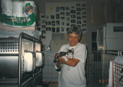 1997 - Mike and Carroway in garage shelter - photos on the walls are of all the cats adopted so far